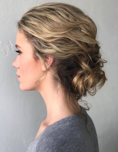 caucasian female side profile of updo hairstyle and natural makeup